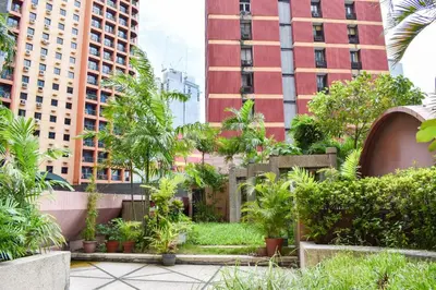 a garden in the middle of a city with tall buildings at Sunette Tower Suites Makati City Center in Manila