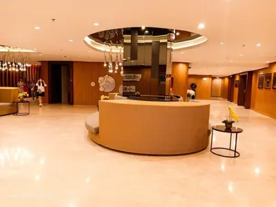a large lobby with a reception desk in a building at Shore 2 Residences 1BR Deluxe Room in MOA Complex in Manila