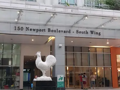 a statue of a rooster in front of a building at Alps Guesthouse at 150 Newport Blvd near T3 in Manila