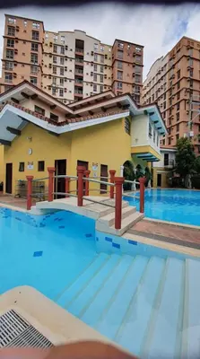 a large swimming pool in front of a building at Near Manila Airport, MAILZ HOMEZ COZY Studio Condo, Full Kitchen, Swimming Pool, WIFI, 11P in Manila