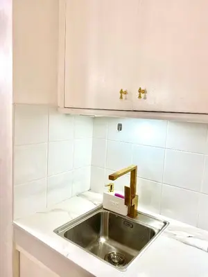 a kitchen sink with a faucet on top of it at RK Maisson Roiyale Pasig in Manila