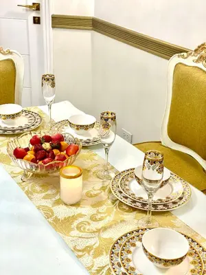 a table with plates and glasses and a bowl of fruit at RK Maisson Roiyale Pasig in Manila