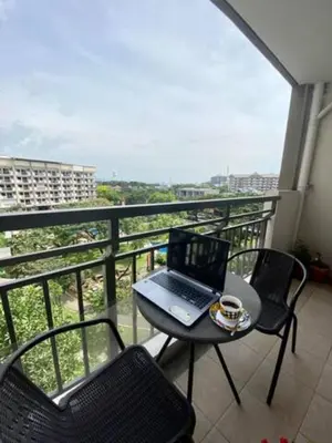 a laptop computer sitting on a table on a balcony at Stylish 2 Bedroom Condo Near BGC and Airport with Fast WiFi in Manila