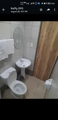 a bathroom with a toilet and a sink at OYO 1011 First Hotel in Manila