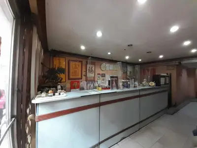 a kitchen with a long counter in a room at OYO 1011 First Hotel in Manila