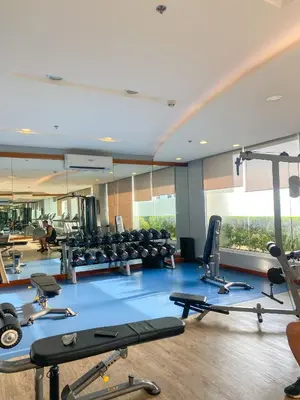 a gym with a lot of treadmills and machines at Deluxe Room w/ Pool & Billiards in Manila