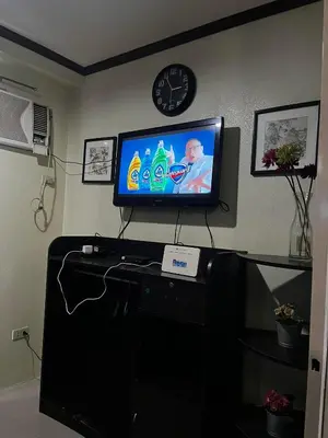 a living room with a television on top of a table at V&J Transient Condotel in Manila