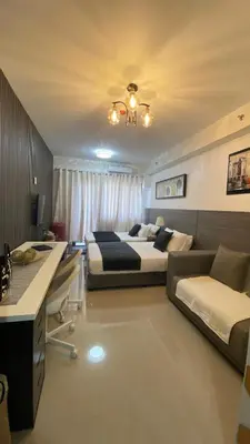 a bedroom with two beds and a couch at Stay COZY and BOUJEE in Manila
