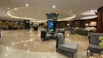 a lobby with chairs and a table in a building at Stay COZY and BOUJEE in Manila