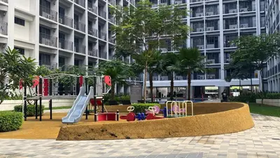 a playground in front of a building with a slide at Stay COZY and BOUJEE in Manila