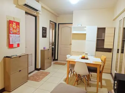 a kitchen with a table and chairs in a room at Available Resort Type Condo Unit in Manila