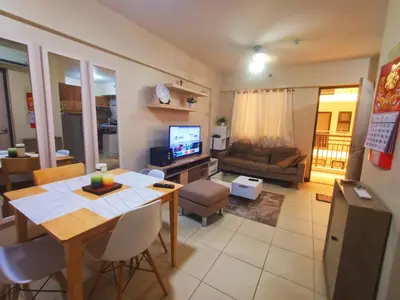 a living room with a table and a dining room at Available Resort Type Condo Unit in Manila