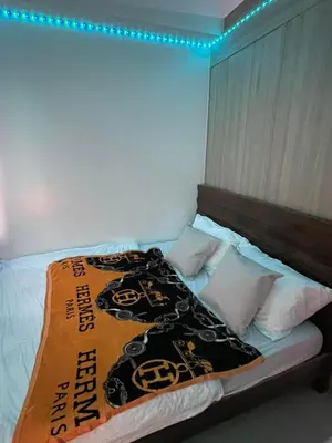 a bedroom with a bed with a pirate blanket on it at Shore residences Ph in Manila