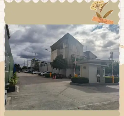 a building with a parking lot in front of it at Avery's Place SMDC CHARM in Manila