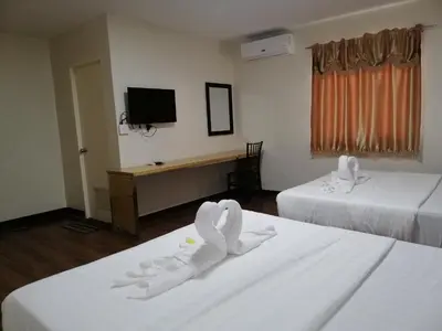 a hotel room with two beds with towels on them at Meaco Royal Hotel - Biñan Laguna in Biñan