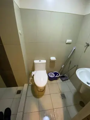 a bathroom with a toilet and a sink at Breeze Residences 26th floor in Manila