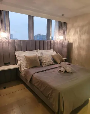 a large bed in a room with a large window at Uptown Parksuites Tower 1 at BGC - Staycations Up Above 12 in Manila