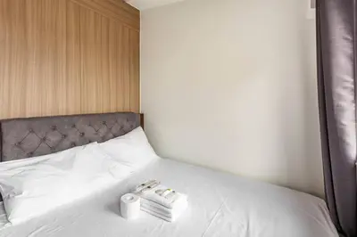 a bed with two rolls of toilet paper on it at BTS Be The Ace at MOA in Manila