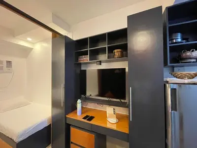 a small room with a bed and a small kitchen at M&Ms Place in Dasmariñas