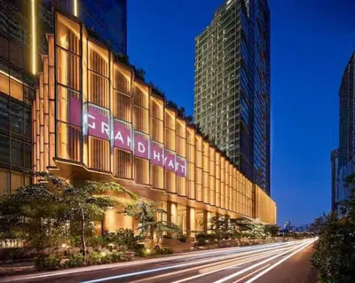 a building with a sign on the side of it at LUXESTAYSMNL ELEGANT FAMILY 2BR SUITE POOLGYM 400MBPS WIFI NETFLX AMAZING CITY VIEW in Manila