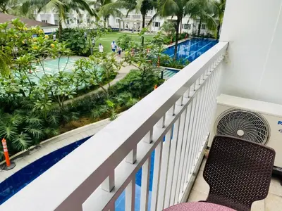 a balcony with a bench looking out at a pool at SHORE RESIDENCE D14 shortwalk Mall of asia near airport in Manila