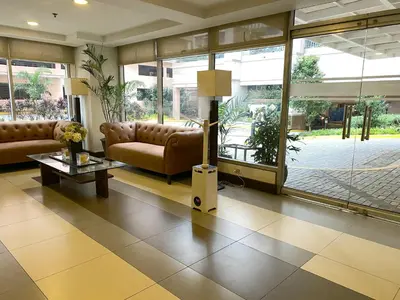 a lobby with couches and a lamp in a building at Avida Towers New Manila near Crame, Cubao and Greenhills in Manila
