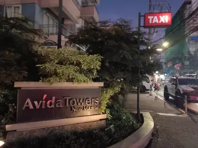 a sign for aania towers new market on a street at Avida Towers New Manila near Crame, Cubao and Greenhills in Manila