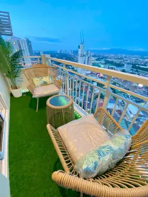 a balcony with a bench and chairs on a building at Cozy 1 BR Scandinavian/Tropical Condo with Balcony & Parking in Manila