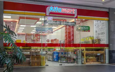 a store front of a grocery store with an air mart sign at Relaxing Apt Bgc Business Ready with 84inch Cinema in Manila
