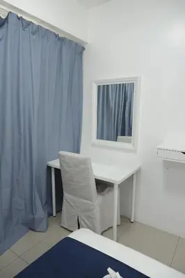 a white desk with a mirror and a chair at NAIA Airport 956 DYNASTEL SHORE Staycation in Manila