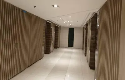 a hallway of a building with wooden walls and a tile floor at MOA Arena 1155 CONDOTEL DYNASTEL SHORE in Manila