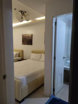 a bedroom with a bed and a ceiling fan at 60 percent Off Deluxe Ocean View Rooms FREE Pool and FREE Sauna Access Included Perfect Location Near US Embassy, NAIA, Makati, BGC, Mall of Asia, and Chinatown Dont Miss Out Book Now and Save Updated Price 2025 in Manila