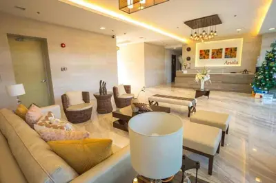 a living room with a couch and a christmas tree at Staycation bigger room in Manila