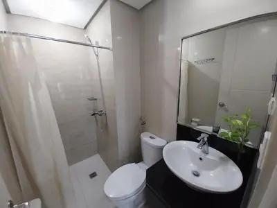 a bathroom with a toilet and a shower and a sink at Alps at 150 Newport Blvd Condominum near T3 in Manila