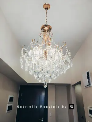a large glass chandelier hanging from a ceiling at Perfect for Working, Quiet & Relaxing at Uptown BGC in Manila
