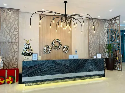 a lobby with a reception desk with a chandelier at Executive Suite in Bonifacio Global City in Manila