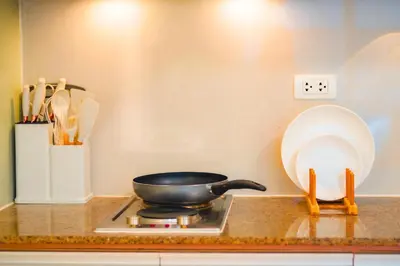 a frying pan sitting on a stove in a kitchen at 400mpbs, Free pool access! Eastwood LeGrand 3 - Mowai Suites in Manila