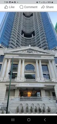 a picture of a building in front of a building at Cozy Pad BGC in Manila