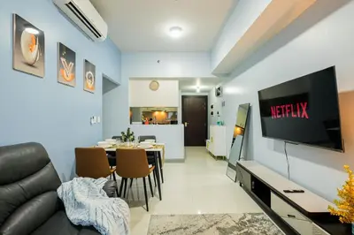 a living room with a couch and a dining room at Luxurious 2 Bedroom in Uptown BGC Taguig in Manila