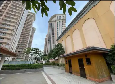 a building in a city with tall buildings at Cozy Place @ Venice Luxury Residences in Manila