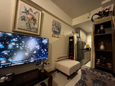 a living room with a large flat screen tv on the wall at Penthouse Lvl Luxury Cndo Nr MOA in Manila