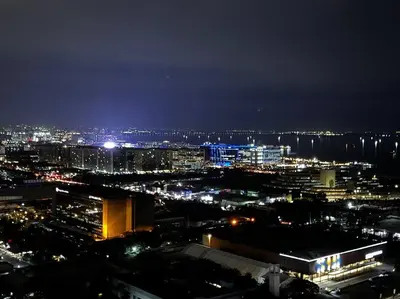 a view of a city at night with lights at Penthouse Lvl Luxury Cndo Nr MOA in Manila