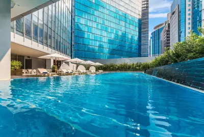 a large swimming pool in front of a building at Ascott Bonifacio Global City Manila in Manila