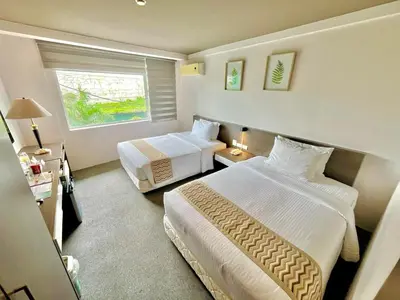 a hotel room with two beds and a window at 88 Courtyard Hotel in Manila