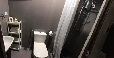 a small bathroom with a toilet and a sink at Cozy 1-BR Flat in Air Residences Makati in Manila