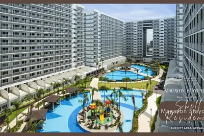 an aerial view of a resort with two pools at Magayon Staycation Shell Residences Mall of Asia in Manila