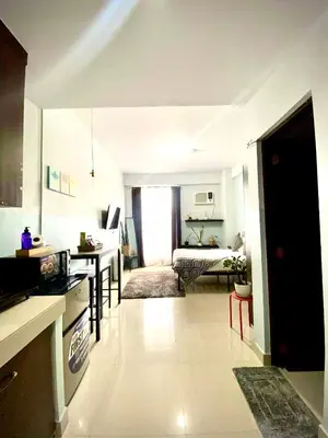 a kitchen and living room with a table and a dining room at Buenbyahe Rooms Studio Type Mandaluyong Edsa Shaw MRT Studio at F Residences Under new management in Manila