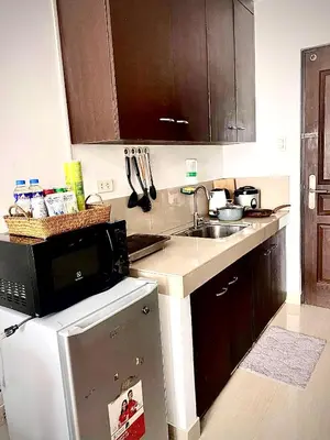 a kitchen with a sink and a microwave at Buenbyahe Rooms Studio Type Mandaluyong Edsa Shaw MRT Studio at F Residences Under new management in Manila