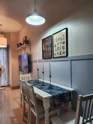 a dining room with a table with candles on it at My Humble Abode at Shore 3 in Manila