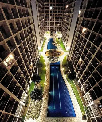 an overhead view of a pool between two tall buildings at SHORE RESIDENCE D17 shortwalk Mall of asia near airport in Manila